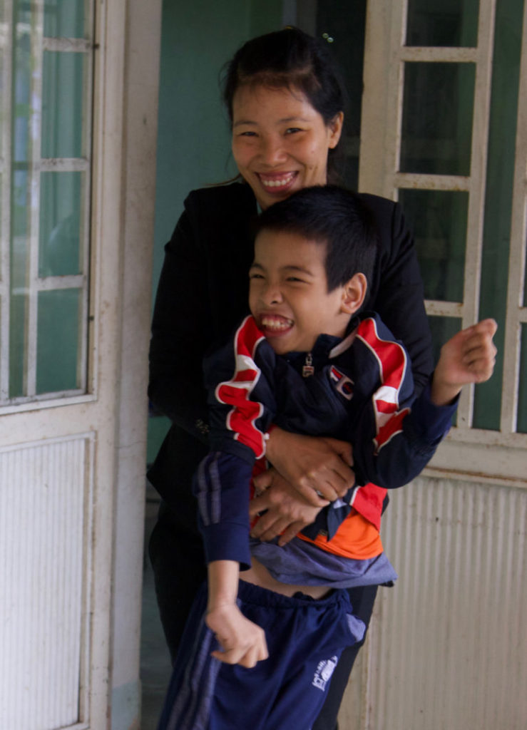 Khang’s mom gives her son a hug after school. “Without Kianh Foundation,” she says, “our lives — my son’s life — would not be what they are now.”