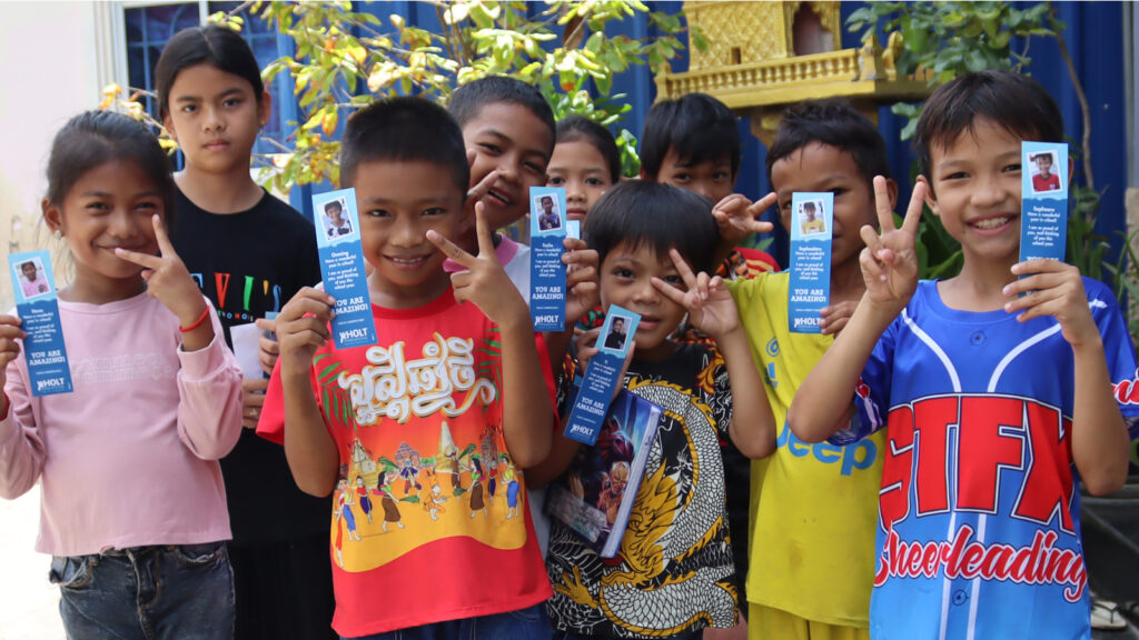 Group of children holding up the bookmarks
