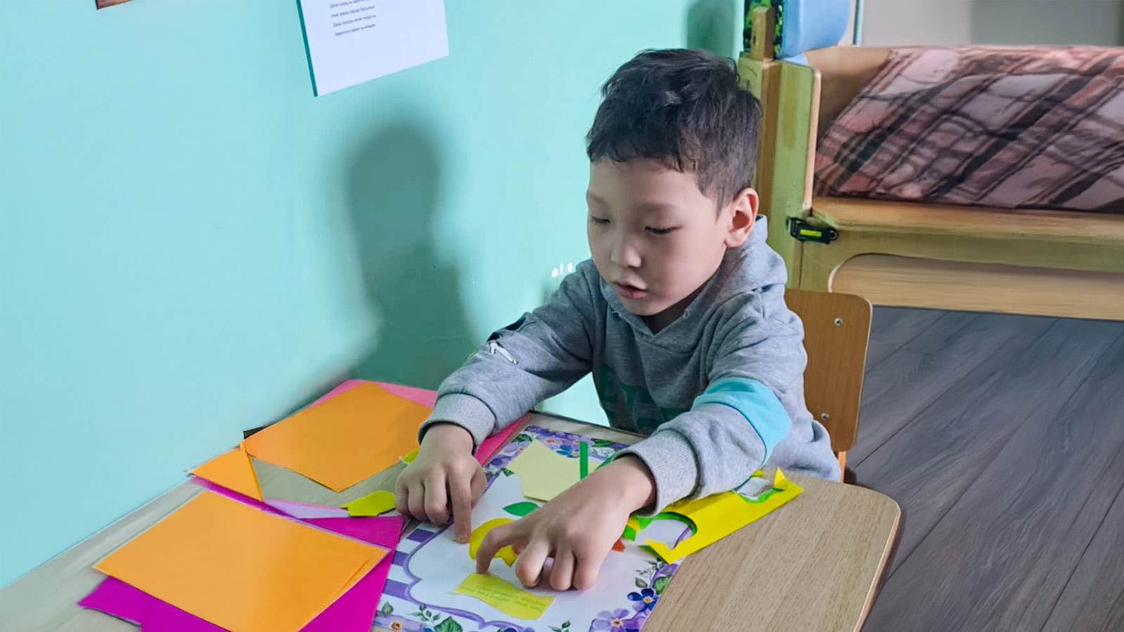 a child in Mongolia creates art, thanks to donor support for education!